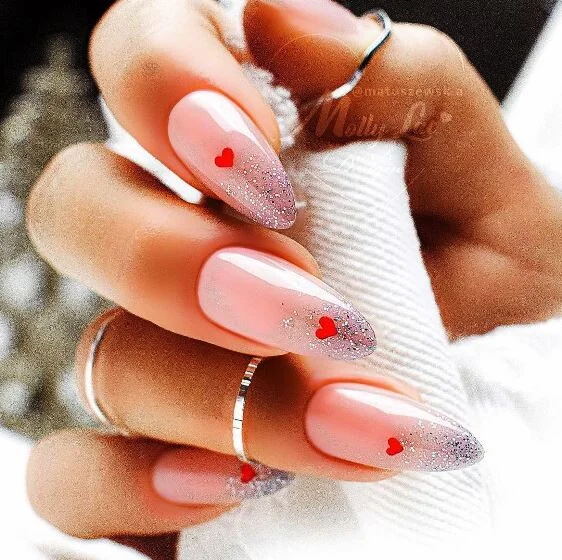 Cute pastel Valentine's day nail design with glitter and hearts