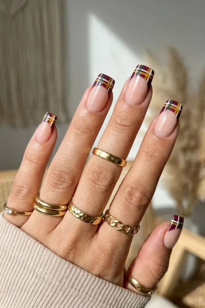 Plaid French tip nails with dark green and brown lines